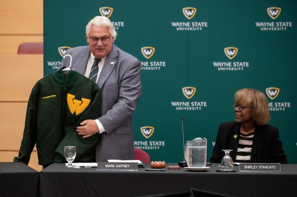Wayne State University Board of Governor chair Mark Gaffney presents the letterman jacket to newly elected president Kimberly Andrews Espy during Board of Governors meeting at Spencer M. Partrich Auditorium in Detroit on Friday, June 30, 2023.