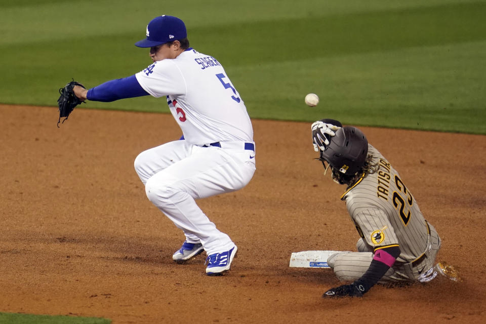 San Diego Padres' Fernando Tatis Jr., right, steals second base as Los Angeles Dodgers shortstop Corey Seager (5) misses the throw from home plate during the fourth inning of a baseball game Thursday, April 22, 2021, in Los Angeles. (AP Photo/Marcio Jose Sanchez)