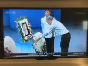 Prime Minister Lee Hsien Loong lays a wreath next to S R Nathan’s casket at the UCC. (Photo: TV screenshot)