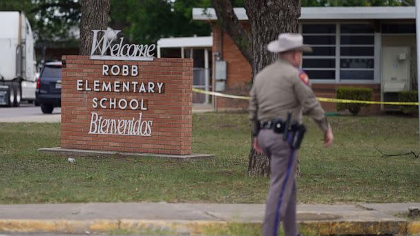 PHOTO: An officer walks outside of Robb Elementary School in Uvalde, Texas, May 24, 2022. (Allison Dinner/AFP via Getty Images)