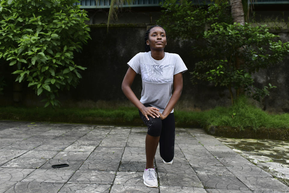 In this photo taken on Wednesday, Oct. 14, 2020, Dodeye Ewa, 16 year old work out inside her family compound in Calabar, Nigeria. The third child is bothered by President Donald Trump's rhetoric and his policies toward international students, most recently one announced Friday that limits their stays in the U.S. to two or four years with uncertainty about whether their visas will be extended. (AP Photo/Daniel H Williams )