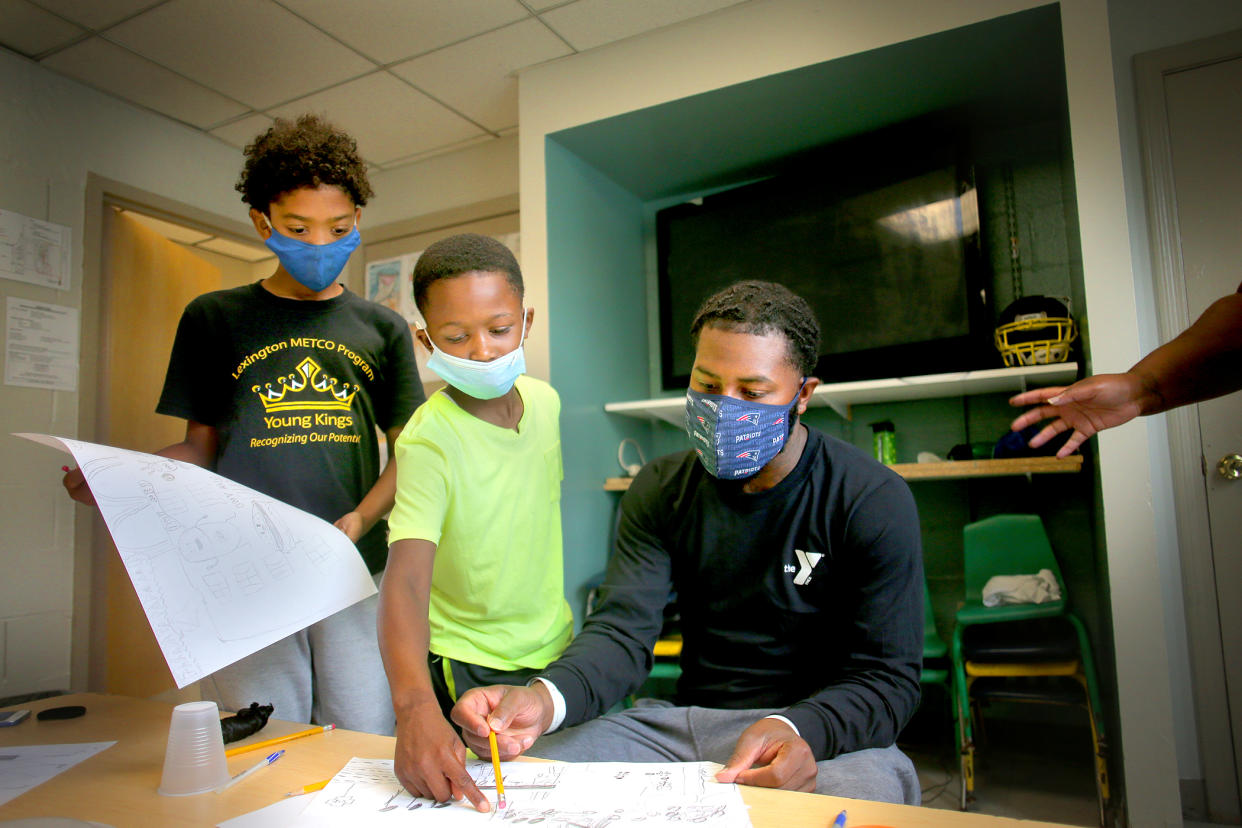 Two students with their teacher 