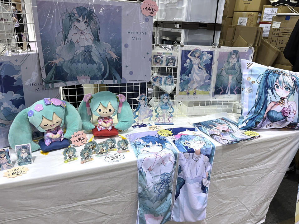 Dolls, T-shirts and other items are sold at a Tokyo suburb hall, Makuhari Messe, in Chiba, Japan, to celebrate the 16th birthday of Japanese Vocaloid Hatsune Miku, Friday, Sept. 1, 2023. She is Japan's most famous Vocaloid, a computer-synthesized singing voice software that, in her case, comes with a virtual avatar. (AP Photo/Yuri Kageyama)