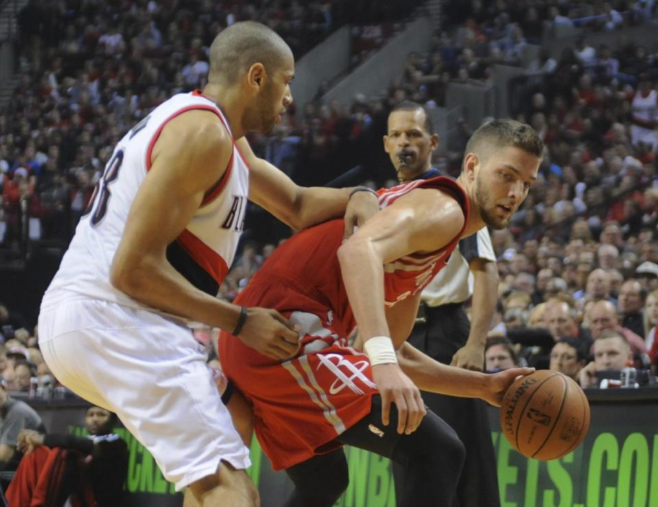 Houston Rockets' Chandler Parsons (25) works against Portland Trail Blazers' Nicolas Batum (88) during the first half of game four of an NBA basketball first-round playoff series game in Portland, Ore., Sunday March 30, 2014. (AP Photo/Greg Wahl-Stephens)