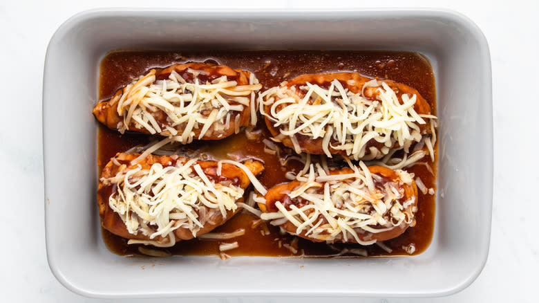 Cheese-topped barbecue chicken in baking dish