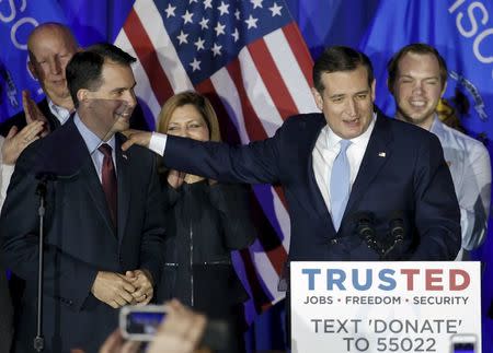 U.S. Republican presidential candidate Ted Cruz celebrates with Wisconsin Governor Scott Walker (L) during a Wisconsin primary night rally at the American Serb Banquet Hall in Milwaukee April 5, 2016. REUTERS/Kamil Krzaczynski