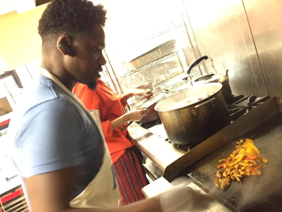 Ahmed Omar works at his restaurant, Kismayo Kitchen, in Burlington on Oct. 18, 2019.