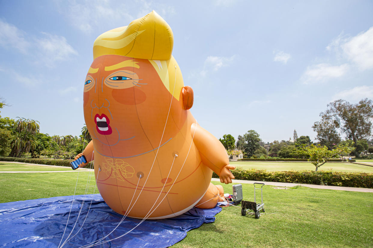 A man was arrested after allegedly stabbing and destroying the giant "Baby Trump" balloon during protests outside of the LSU-Alabama game in Tuscaloosa.