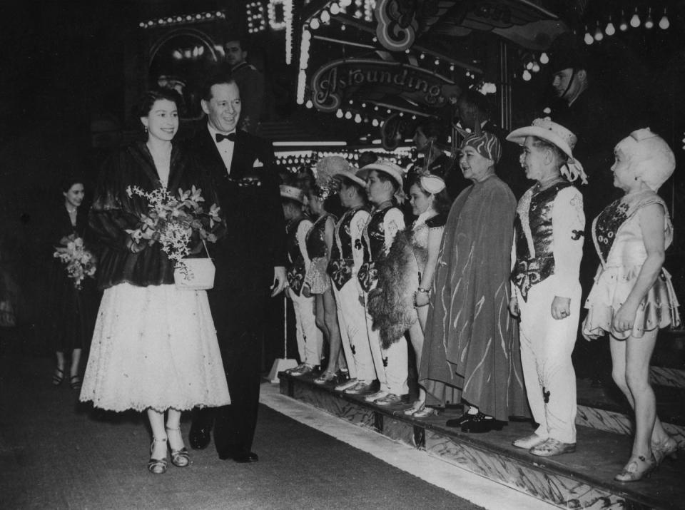 <p>Even royals deserve to have some Christmas fun. Here, Cyril Bertram Mills—the King of the Modern Circus—greets Queen Elizabeth with flowers, as she attends the Bertram Mills Christmas Circus.</p>