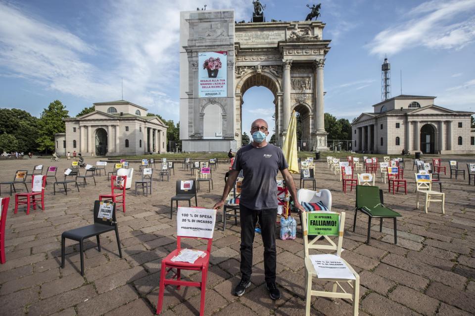 FILE - In this Saturday, May 9, 2020 file photo, restaurant owner Paolo Polli stages a protest in Milan, Italy. The coronavirus pandemic is gathering strength again in Europe and, with winter coming, its restaurant industry is struggling. The spring lockdowns were already devastating for many, and now a new set restrictions is dealing a second blow. Some governments have ordered restaurants closed; others have imposed restrictions curtailing how they operate. (AP Photo/Luca Bruno, File)