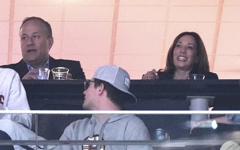 Vice President Harris and husband Douglas Emhoff watch during the second half of a first-round college basketball game