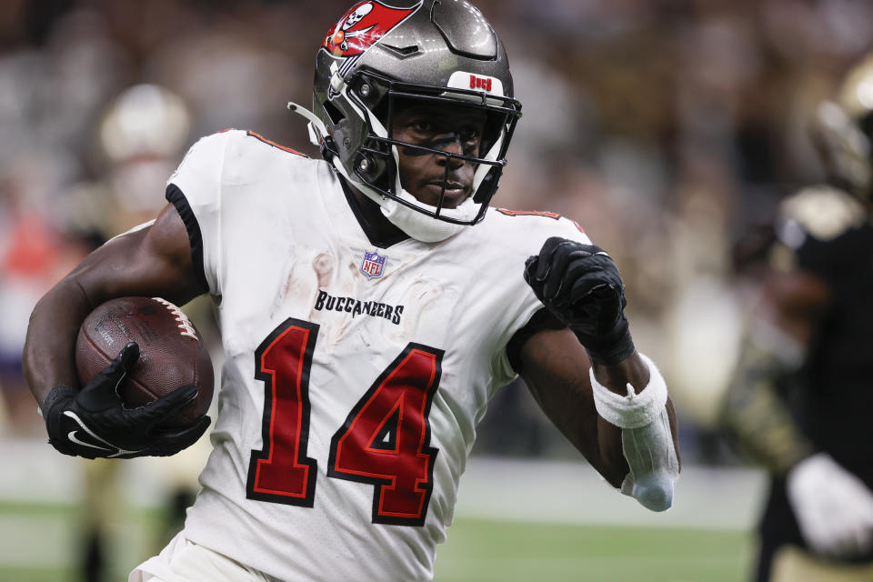 Tampa Bay Buccaneers wide receiver Chris Godwin (14) carries the ball after a reception in the second half of an NFL football game against the New Orleans Saints in New Orleans, Sunday, Oct. 1, 2023. (AP Photo/Butch Dill)