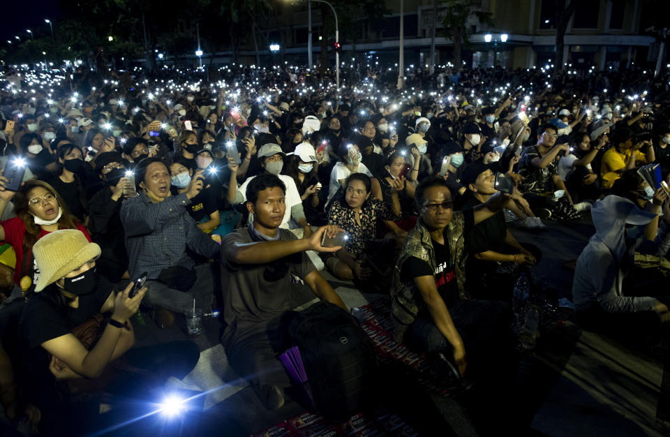 Pro-democracy activities display mobile phones with flash lights on during a protest at Democracy Monument in Bangkok, Thailand, Sunday, Aug, 16, 2020. A two-day rally planned for this weekend is jangling nerves in Bangkok, with apprehension about how far student demonstrators will go in pushing demands for reform of Thailand’s monarchy and how the authorities might react. More than 10,000 people are expected to attend the Saturday-Sunday event. (AP Photo/Gemunu Amarasinghe)