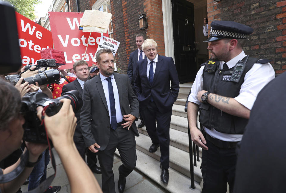 Conservative Party leadership contender Boris Johnson, centre right, leaves his office in Westminster area of London, Monday July 22, 2019. Voting closes Monday in the ballot to elect Britain's next prime minister, from the two contenders Jeremy Hunt and Boris Johnson, as critics of likely winner Boris Johnson condemned his vow to take Britain out of the European Union with or without a Brexit deal.(Yui Mok/PA via AP)