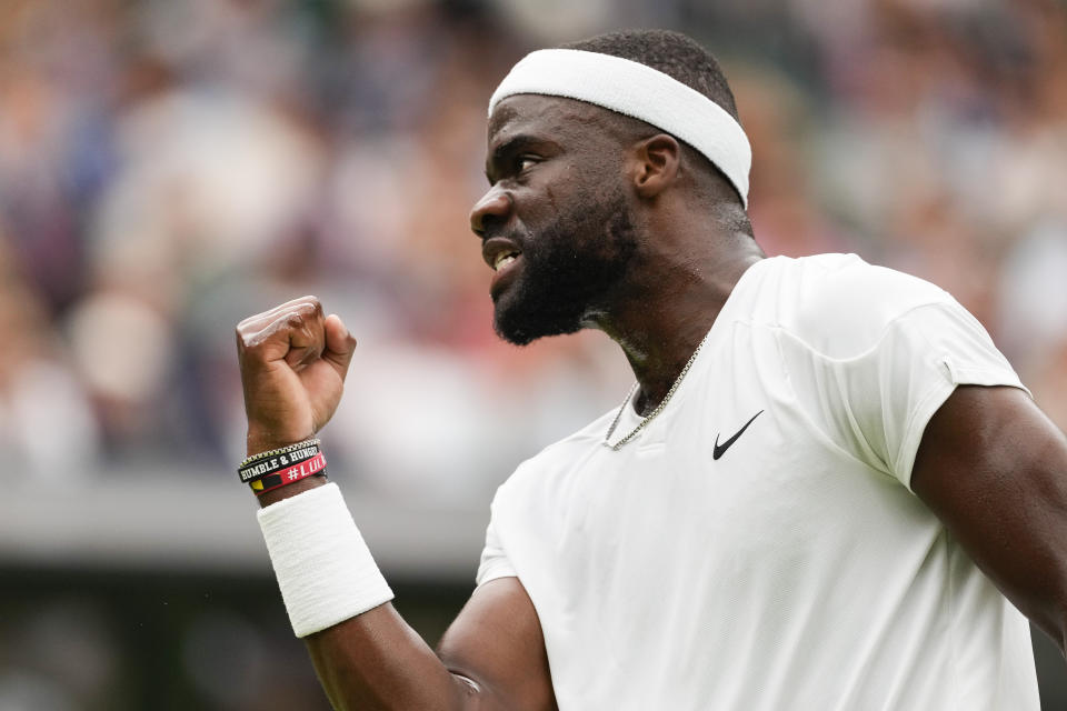 Francis Tiafoe of the United States reacts after winning a point against Spain's Carlos Alcaraz during their third round match at the Wimbledon tennis championships in London, Friday, July 5, 2024. (AP Photo/Alberto Pezzali)