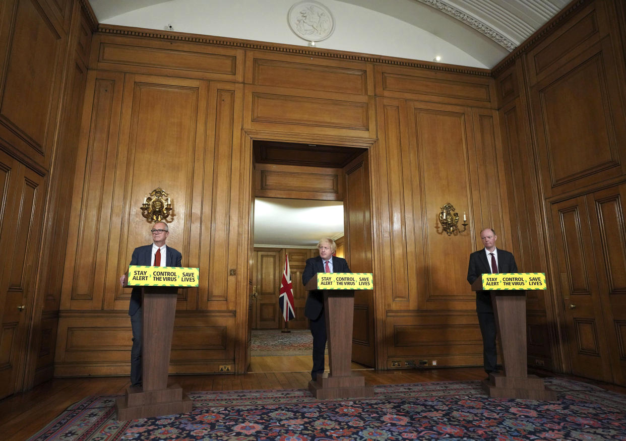 In this photo issued by 10 Downing Street, from left, Chief Scientific Adviser Sir Patrick Vallance, Britain's Prime Minister Boris Johnson and Chief Medical Officer Professor Chris Whitty take part in a coronavirus media briefing in Downing Street, London, Wednesday June 10, 2020. (Pippa Fowles/10 Downing Street via AP)