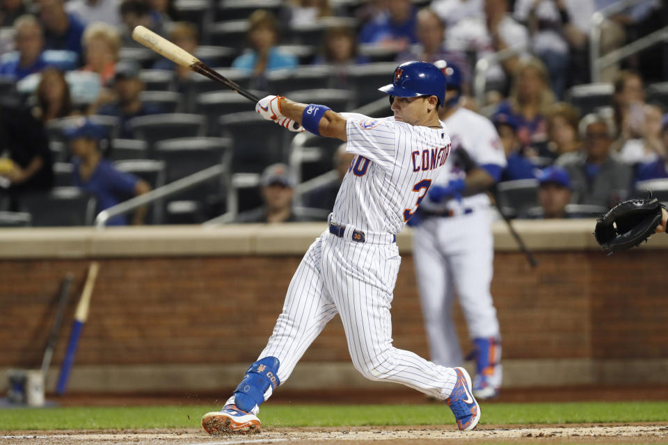 New York Mets' Michael Conforto hits a first-inning RBI double against the Miami Marlins during the first inning of a baseball game Wednesday, Sept. 25, 2019, in New York. Conforto advanced to third on an error. (AP Photo/Kathy Willens)