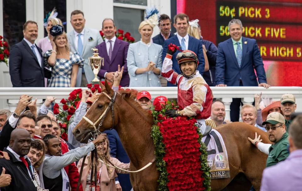 Jockey Sonny Leon and Rich Strike pause for a photo with friends, family and supporters after winning the 148th running of the Kentucky Derby at Churchill Downs.