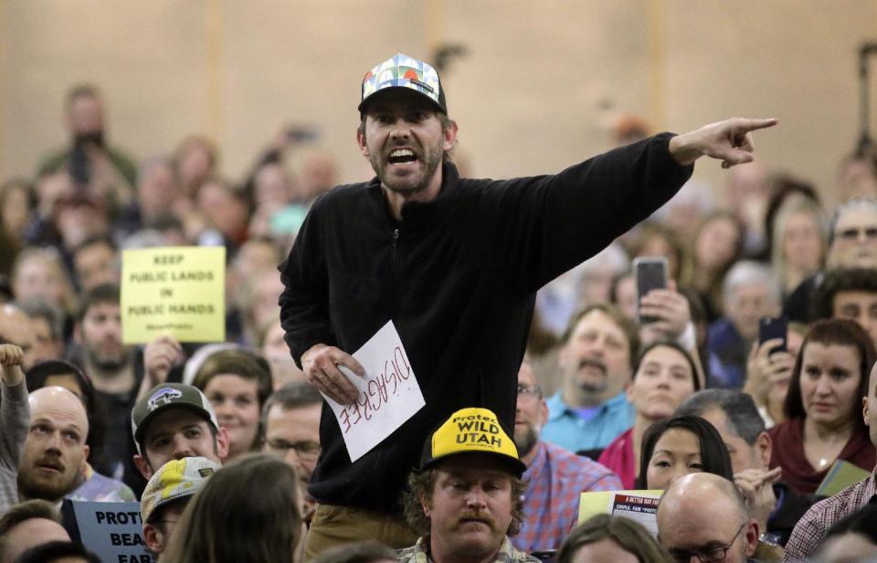 A person shouts to Rep. Jason Chaffetz during his town hall meeting at Brighton High School, Thursday, Feb. 9, 2017, in Cottonwood Heights, Utah. Hundreds of people lined up early for a town hall with Chaffetz on Thursday evening, many holding signs criticizing the congressman's push to repeal the newly-named Bears Ears National Monument in southern Utah. (AP Photo/Rick Bowmer)