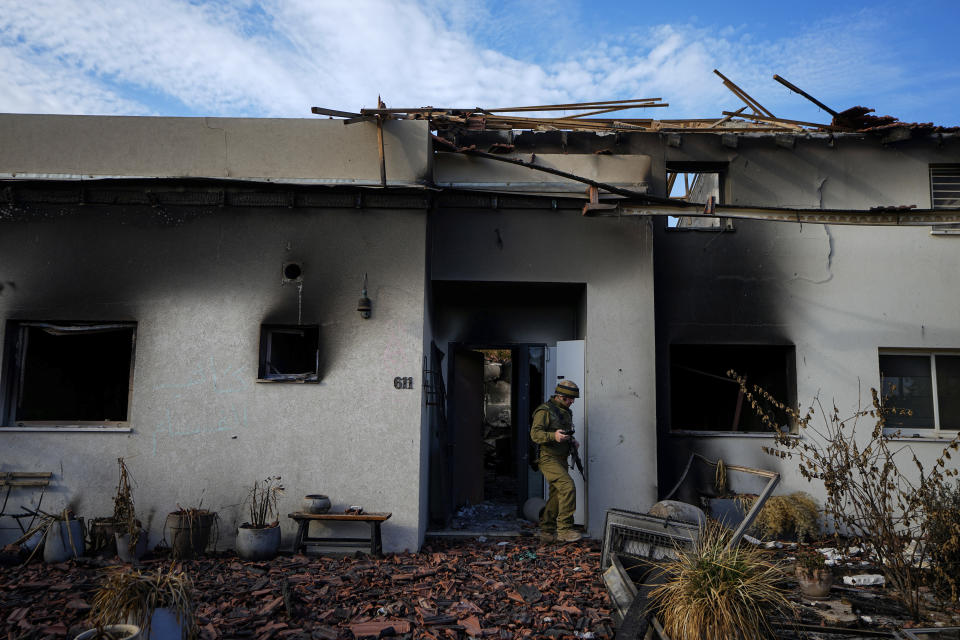 An Israeli soldier inspects a house damaged by Hamas militants in Kibbutz Be'eri, Israel, Tuesday, Oct. 17, 2023. The kibbutz was overrun by Hamas militants from the nearby Gaza Strip on Cot.7, when they killed and captured many Israelis. (AP Photo/Ariel Schalit)