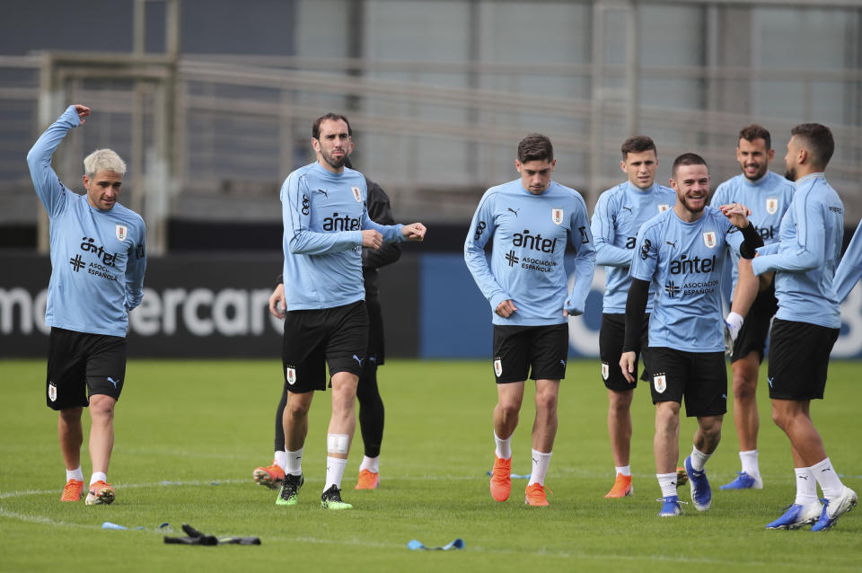 Uruguay soccer players warm up during a practice session in Porto Alegre, Brazil, Wednesday, June 19, 2019. Uruguay will face Japan tomorrow in a Copa America Group C soccer match. (AP Photo/Edison Vara)