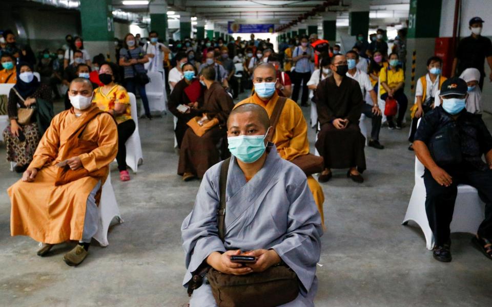 Indonesian monks wait to receive their first dose of China's Sinovac Biotech vaccine - Ajeng Dinar Ulfiana/Reuters