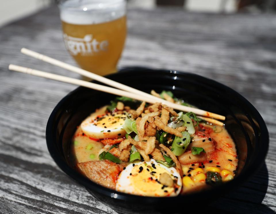 A glass of StacheStrong, a hazy session IPA, with the Ignite the Ramen bowl by Crafted Eats at Ignite.