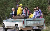 Residents are transported in a pickup truck to be evacuated by helicopter from Jamestown, Colorado, after a flash flood destroyed much of the town, September 14, 2013. Colorado farming communities along the South Platte River were ordered to evacuate ahead of a predicted surge in the flooding, which may have claimed a fifth life and has left many still unaccounted for, authorities said on Saturday. REUTERS/Rick Wilking