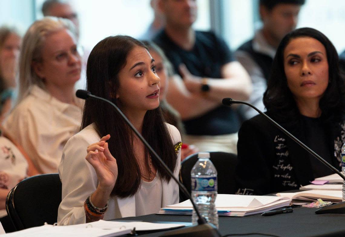 Simone Kaplan, pronouncer and three time Miami Herald Spelling Bee winner and runner up of the National Scripps Spelling Bee in 2019, explains the rules to the contestants during the Miami Herald Miami-Dade/Monroe County Spelling Bee at the New World Center in Miami Beach.