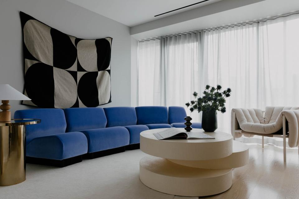 This light-filled living room by Prime Projects in Brooklyn is all about contrast. Stylish silhouettes create a play of light and shadow, adding depth to the space centered around the ’70s vintage Don Chadwick modular sofa.
