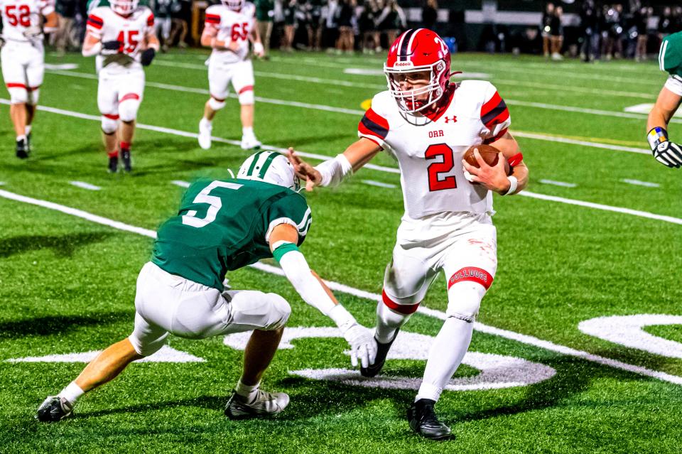 Old Rochester's Noah Sommers stiff arms Dartmouth's Jared Abreu to pick up extra yards.