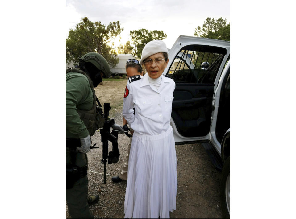 FILE - In this Aug. 20, 2017 file photo provided by the Cibola County Sheriff's Office, Deborah Green, leader of a New Mexico paramilitary religious sect, is arrested outside of the group's secluded Fence Lake, N.M. compound. Green has been sentenced to more than seven decades in prison after her conviction in a child sex abuse case. (Cibola County Sheriff's Office via AP, File)