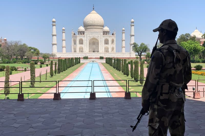 FILE PHOTO: A member of Central Industrial Security Force (CISF) personnel stands guard inside the empty premises of the historic Taj Mahal during a 21-day nationwide lockdown
