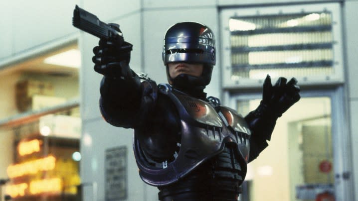 Peter Weller pointing a gun at something offscreen in RoboCop.