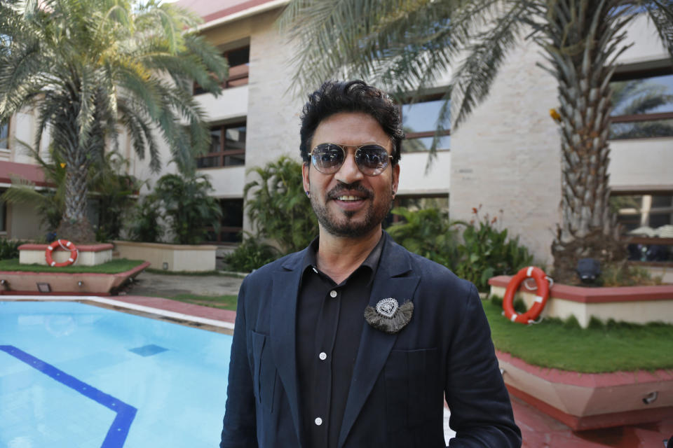 Bollywood actor Irrfan Khan poses before a press conference to promote his upcoming movie "Hindi Medium" in Ahmadabad, India, Wednesday, May 17, 2017. The movie is scheduled to be released on May 19. Irrfan and Saba Qamar seen in poster in background. (AP Photo/Ajit Solanki)