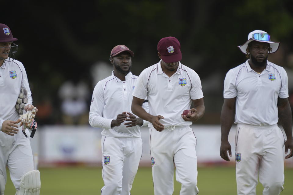 West Indies bowler Gudakesh Motie,centre, holds the ball after taking seven wickets on the first day of the second Test cricket match between Zimbabwe and West Indies at Queens Sports Club in Bulawayo, Zimbabwe, Sunday,Feb, 12, 2023. (AP Photo/Tsvangirayi Mukwazhi)