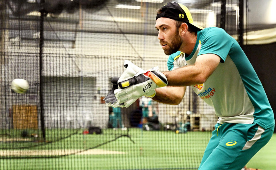 Glenn Maxwell, pictured here practicing with wicketkeeper gloves at an Aussie training session at the T20 World Cup.