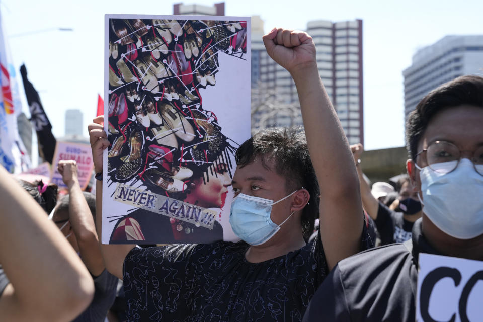 A protester holds a banner with a picture of former First Lady Imelda Marcos, widow of the late strongman, during a rally against presidential frontrunner Ferdinand "Bongbong" Marcos Jr. and running mate Sara Duterte, daughter of the current president, in Pasay, Philippines, Friday, May 13, 2022. Allies of the Philippines' presumptive next president, Marcos Jr., appear set to strongly dominate both chambers of Congress, further alarming activists after the late dictator's son scored an apparent election victory that will restore his family to the seat of power. (AP Photo/Aaron Favila)