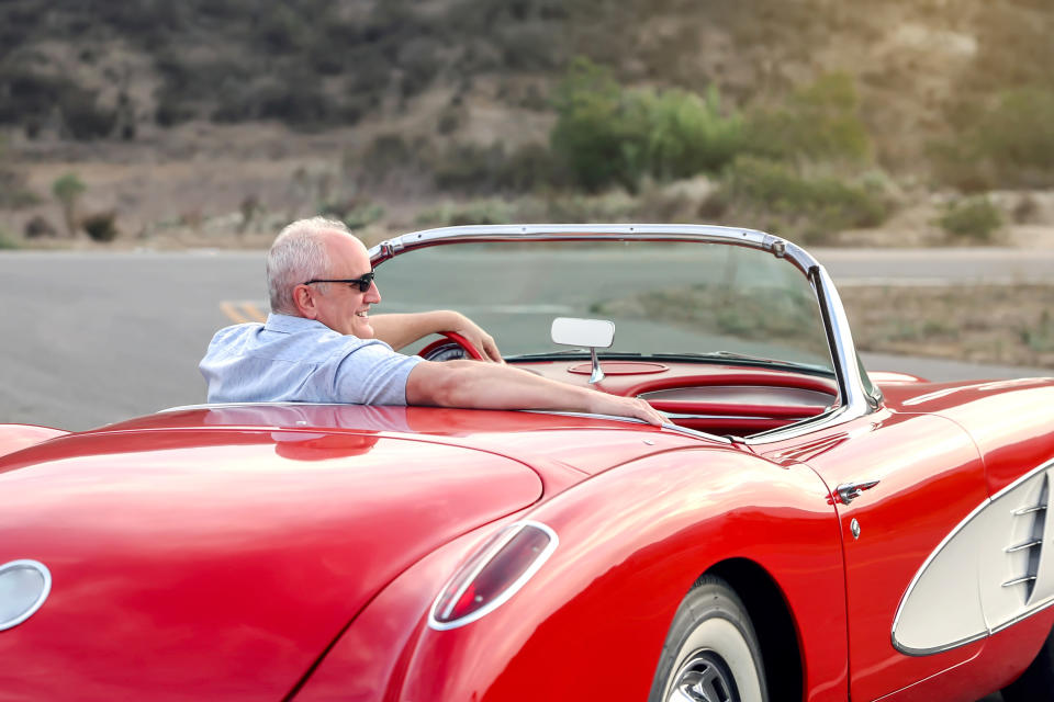 a man driving a sports car