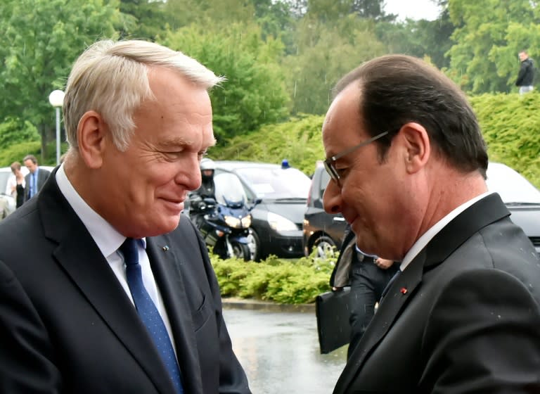 French President Francois Hollande (R) is welcomed by former prime minister Jean-Marc Ayrault before giving a speech in Nantes, western France, on June 12, 2015