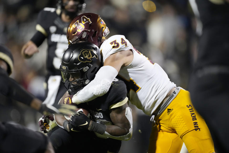 Arizona State linebacker Kyle Soelle, right, tackles Colorado running back Deion Smith after a short gain in the second half of an NCAA college football game Saturday, Oct. 29, 2022, in Boulder, Colo. (AP Photo/David Zalubowski)