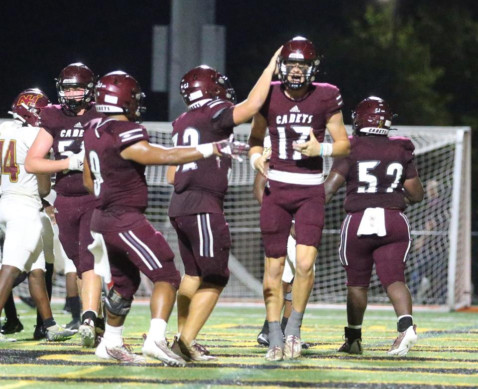 Benedictine quarterback Luke Kromenhoek celebrates with teammates after scoring a touchdown during Friday night's game against New Hampstead.