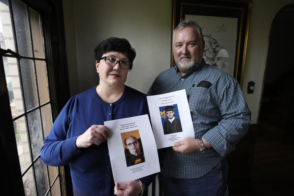 Karen Kobylik and her husband Michael Kobylik hold funeral programs for Karen's children Ruby and Bishop Taverner, Monday, May 1, 2023, in Pontiac, Mich. Ruby shot and killed her boyfriend and brother before taking her own life hours later on May 8, 2022. Kobylik had spent the weeks prior calling police asking them to remove her daughter's firearm. "They said we can't take any guns away from her because we cannot step on her second amendment right," Kobylik told The Associated Press. Michigan is poised to become the 20th state in the nation to pass red flag laws. (AP Photo/Carlos Osorio)