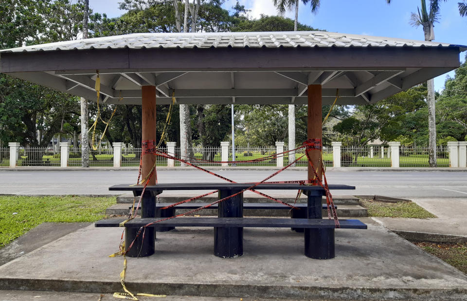 A picnic spot in front of the prime minister's residence is closed off to the public during the COVID-19 pandemic in Suva, Fiji, Friday, June 25, 2021. A growing coronavirus outbreak in Fiji is stretching the health system and devastating the economy. It has even prompted the government to offer jobless people tools and cash to become farmers.(AP Photo/Aileen Torres-Bennett)