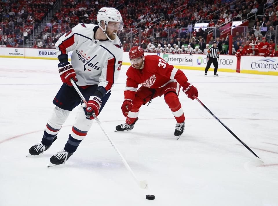 Washington Capitals right wing Anthony Mantha, left, moves the puck against Detroit Red Wings left wing J.T. Compher (37) during the third period of an NHL hockey game Tuesday, Feb. 27, 2024, in Detroit. (AP Photo/Duane Burleson)