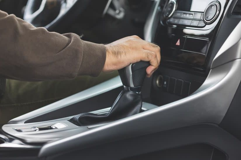 Young asian men getting new car and his hand control the stick shift transmission in luxury car. Male hand changing gear driving car.