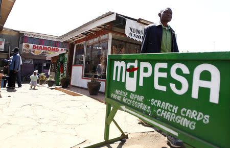 A man walks away from a retail mobile money transfer shop in Ngong township in the outskirts of Kenya's capital Nairobi July 15, 2013. REUTERS/Thomas Mukoya