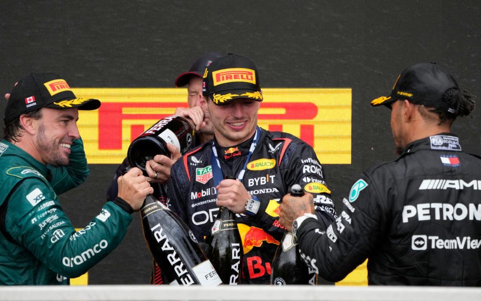 Race winner Red Bull's Max Verstappen, second placed Aston Martin's Fernando Alonso and third placed Mercedes' Lewis Hamilton celebrate