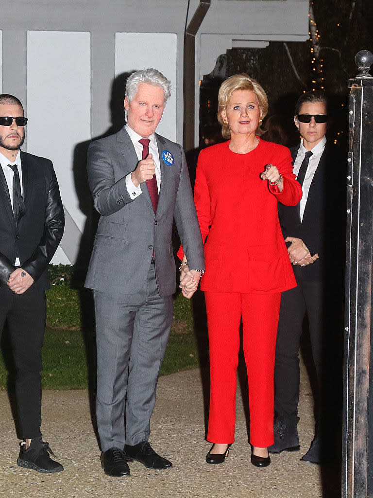 Katy and her partner wearing heavy face prosthetics to look like Bill and Hilary