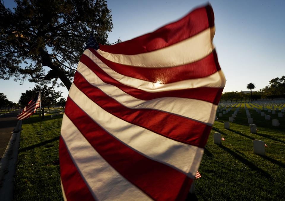 <p>The sun sets over a flag at the Los Angeles National Military Cemetery two days before Memorial Day in Los Angeles, Calif., on May 26, 2018. Memorial Day, which originated after the US Civil War that ended in 1865, is an American holiday honoring the men and women who died while serving in the U.S. military. (Photo: Mark Ralston/AFP/Getty Images) </p>